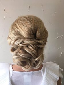 A woman with blonde hair is wearing white.