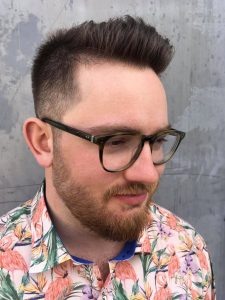 A man with glasses and a beard